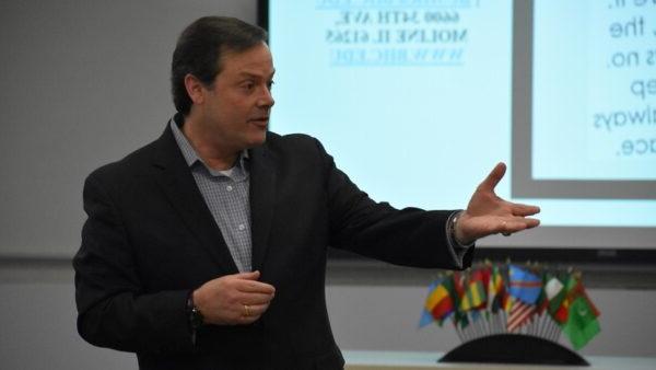 Man in suit gesturing while speaking